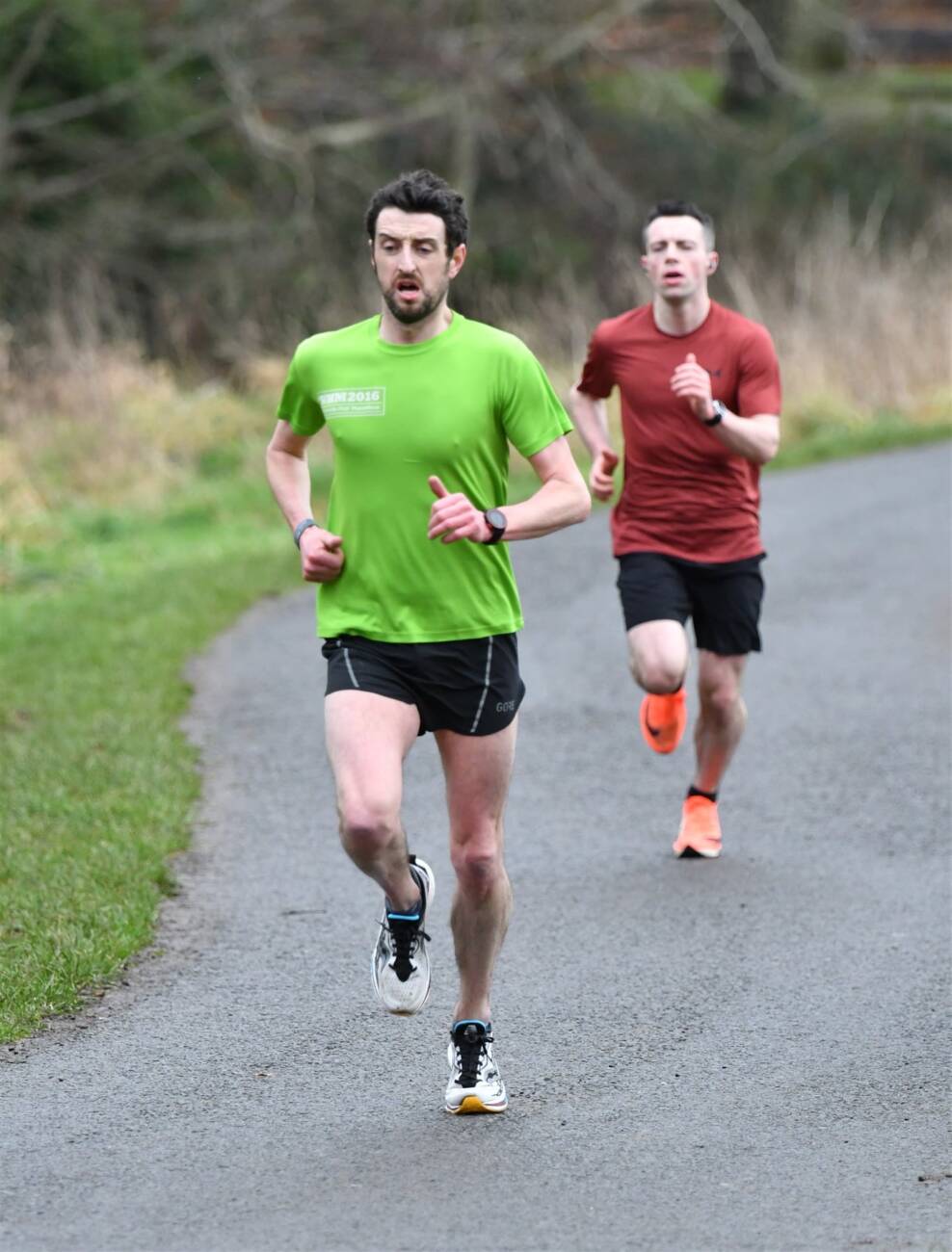 Connor Martin (left) running to second overall at the Antrim Parkrun