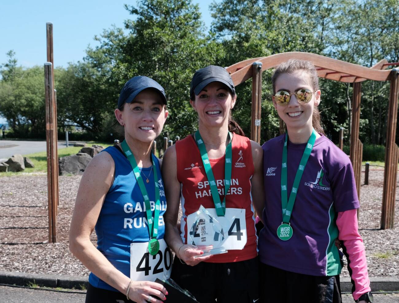 Joanne Taggart (centre) with her trophy for taking first lady in the half marathon at the Washingbay Green Run